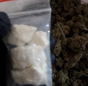Na zdjęciu widoczna marihuana oraz biała torebka foliowa z zawartością mefedronu.