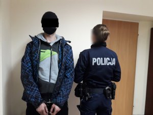 Na zdjęciu widoczny zatrzymany mężczyzna, który stoi przy umundurowanej policjantce.